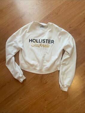 Hollister Cream Cropped Sweatshirt with Navy and Gold Logo